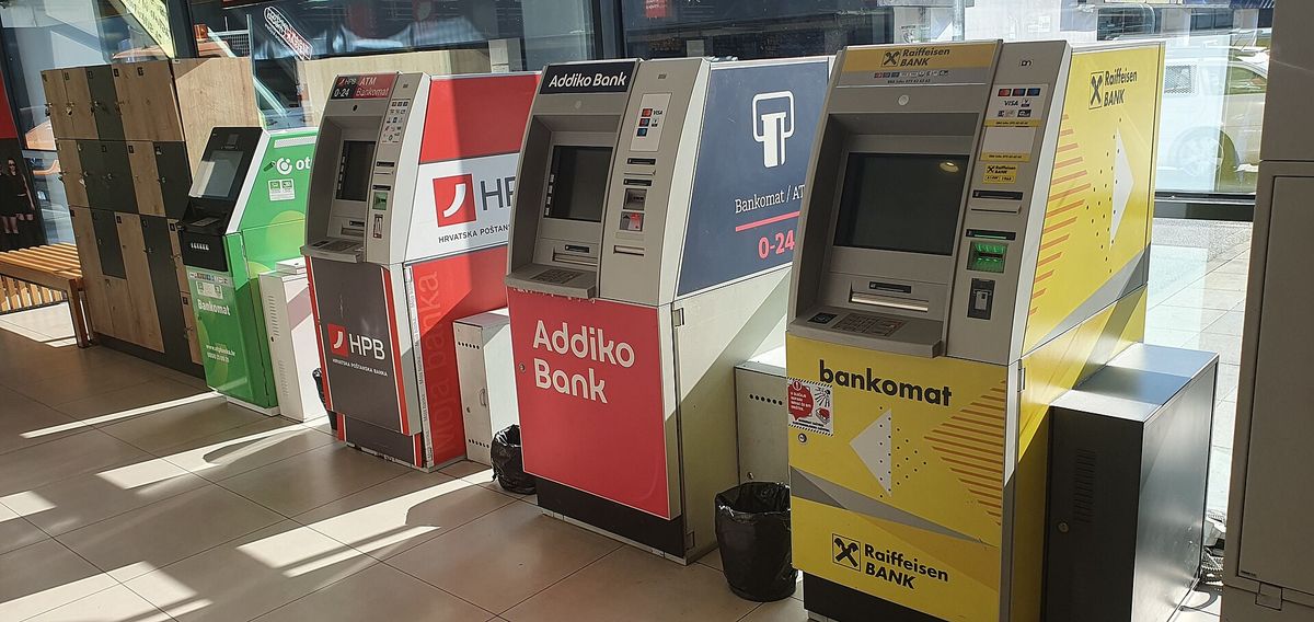 A bank cash machine set into a stone wall on a street in Croatia