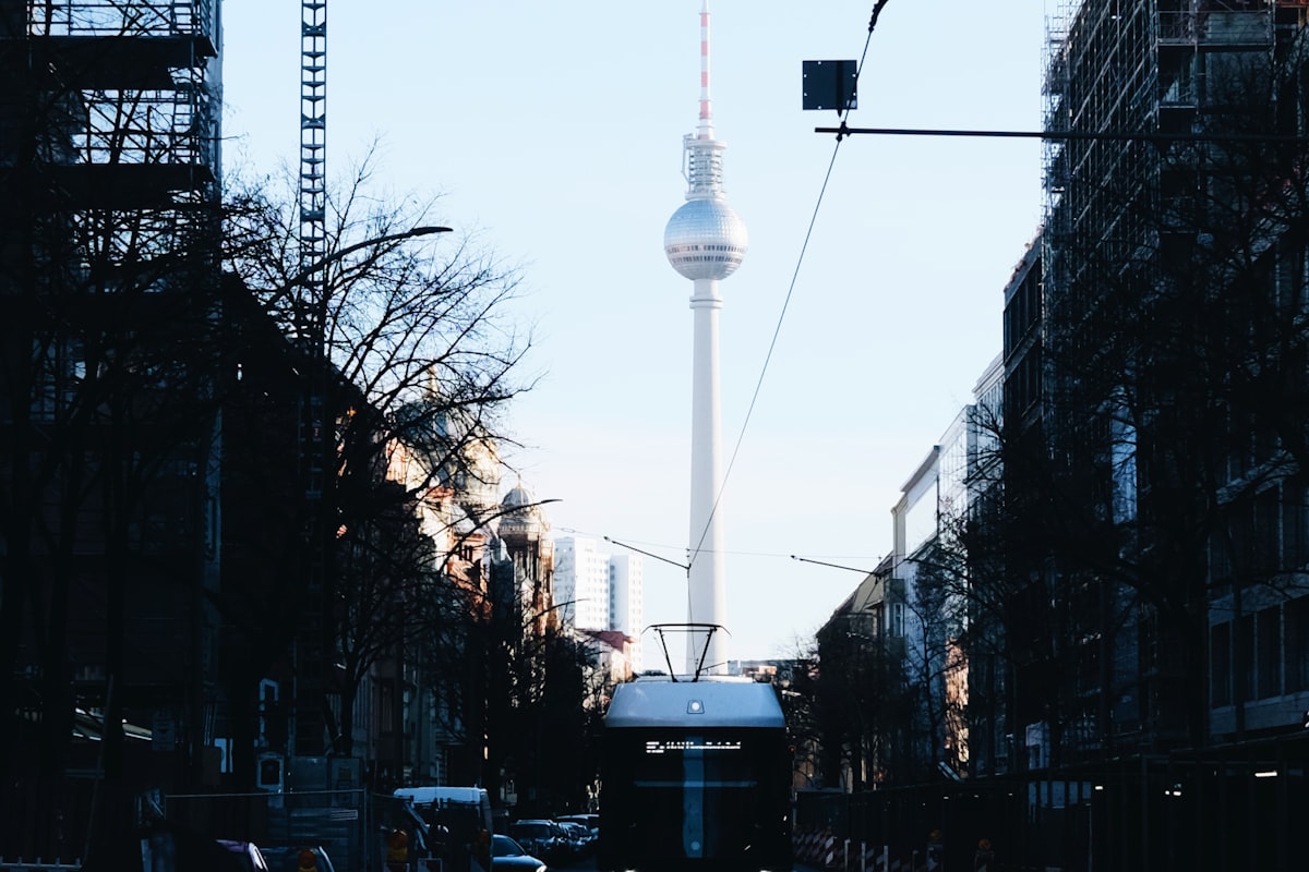 Berlin street scene with a tram and the Fernsehturm television tower in the distance