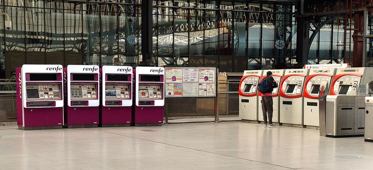 A row of Renfe self-service ticket machines at Principe Pio station in Madrid