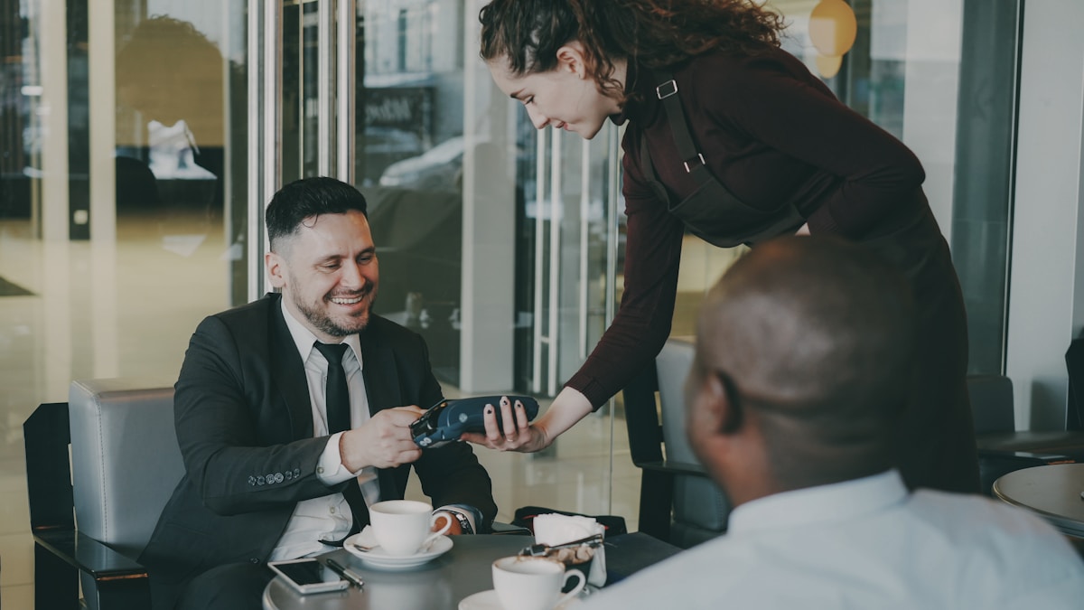 Traveler paying a restaurant bill with a credit card abroad