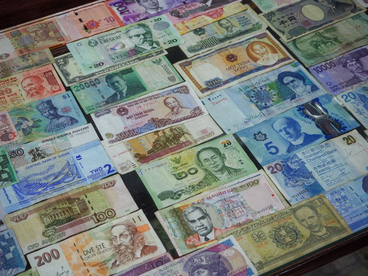 Assorted foreign currency banknotes from various countries laid out on a table
